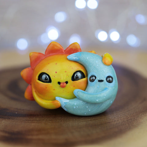 Tongue Out Sun Moon Figurine